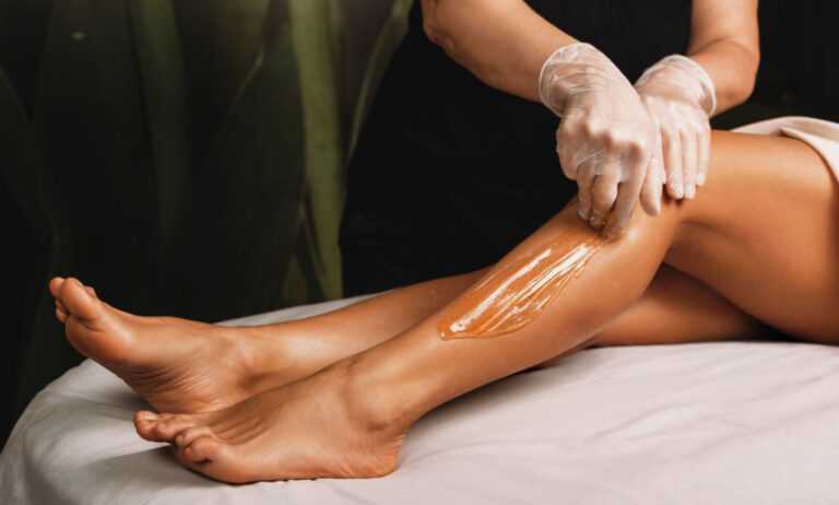 Leg waxing treatment performed by professional